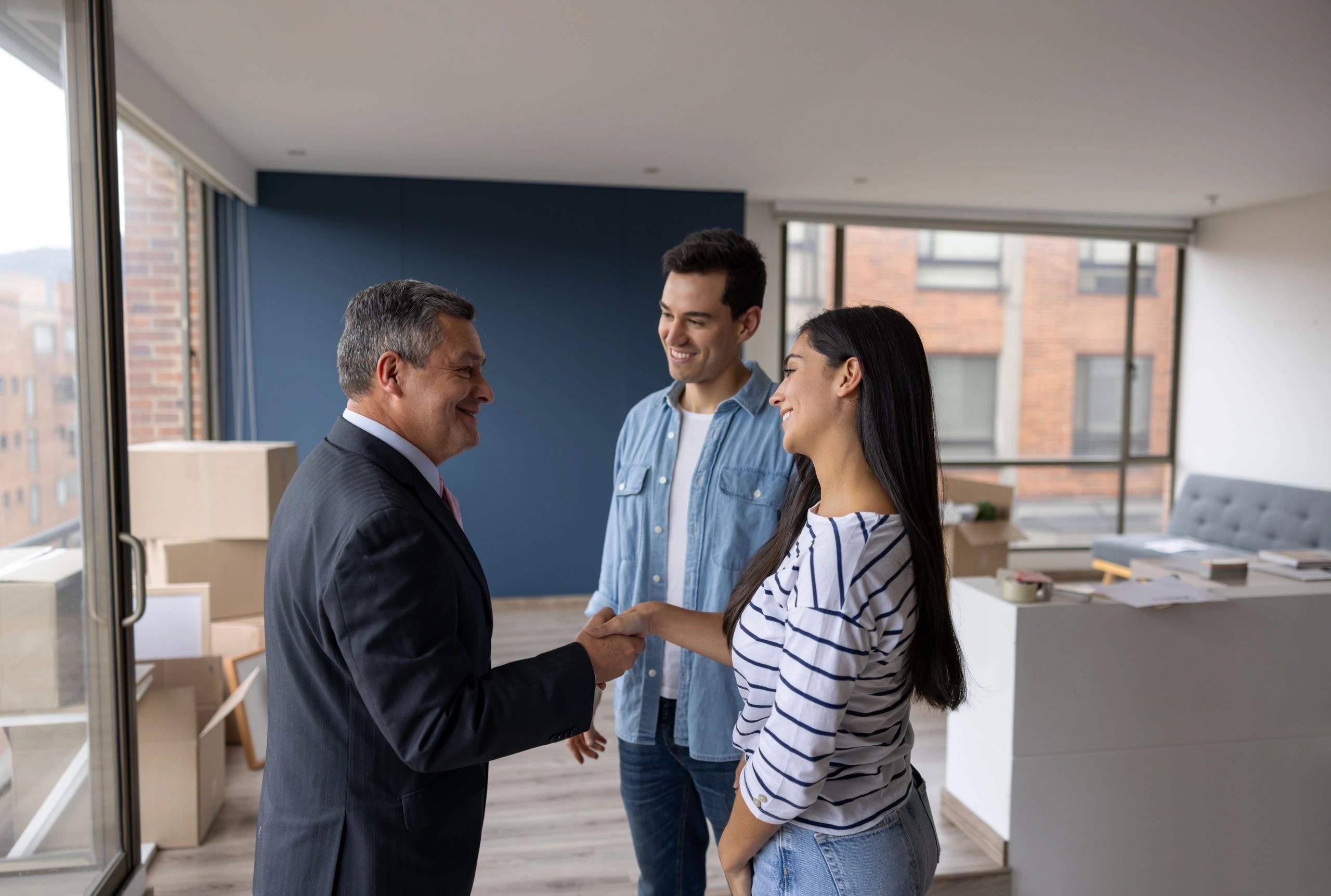 property manager with happy senior tenants in apartment